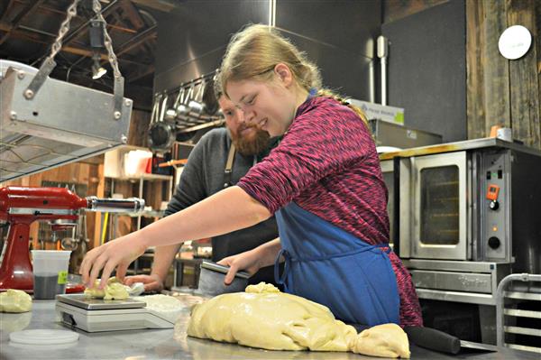 Grayson Norbury prepares pizza dough 